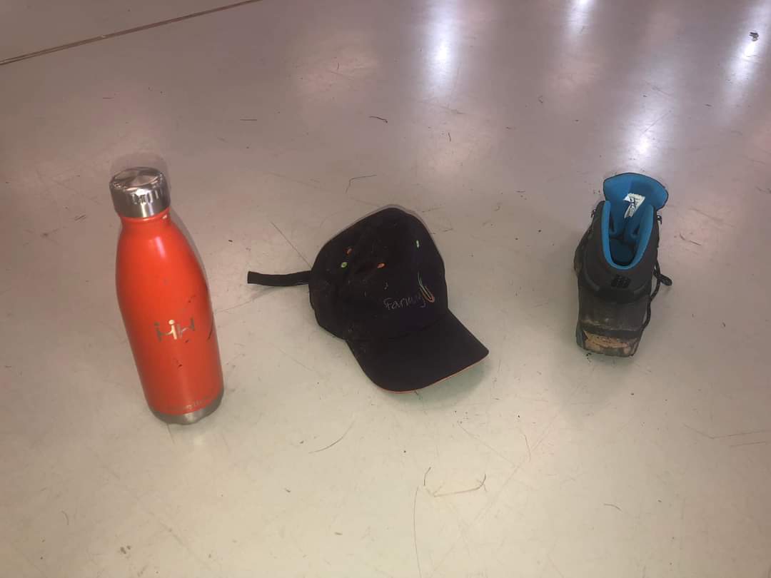 Water bottle, baseball cap and trainer